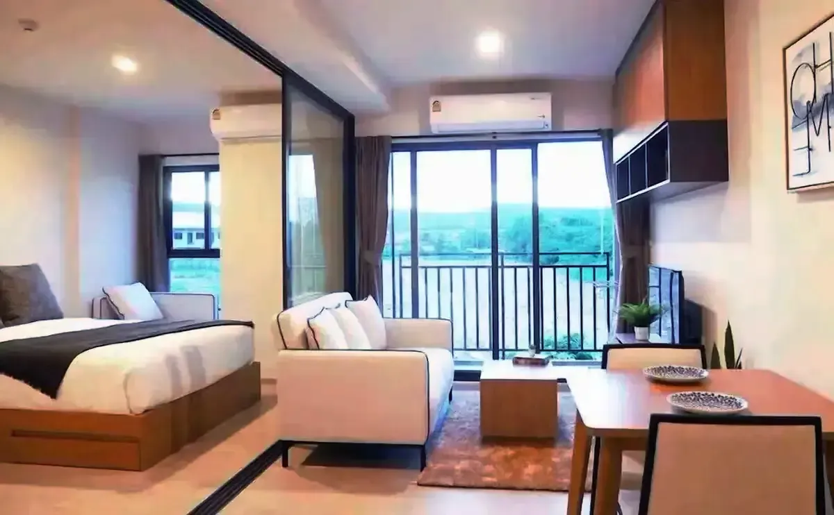 Studio bedroom opening to private balcony with sea views